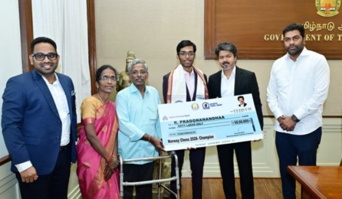 Tamil Nadu CM Vijay presents Rs 50 lakh cheque to Grandmaster Praggnanandhaa for Norway Chess title